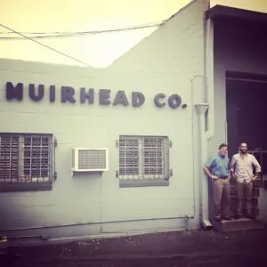 Two men outside Muirhead Co. building.