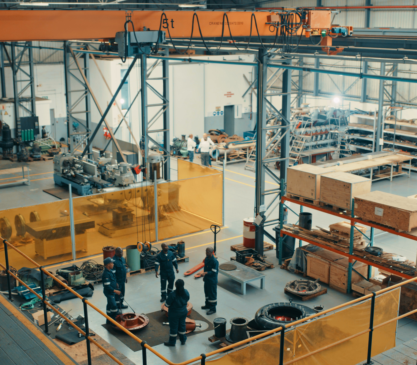 Workers assembling parts in factory setting